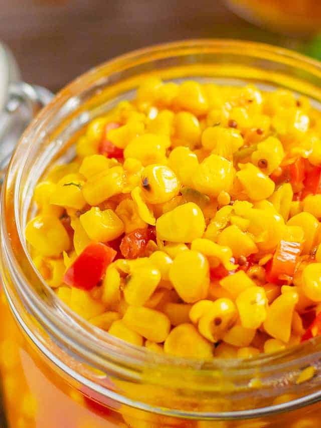 Close up of corn relish in a jar.