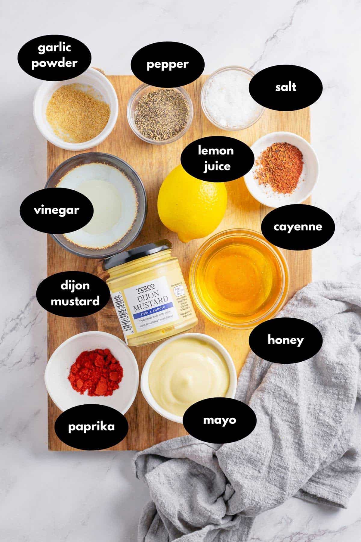 honey mustard sauce ingredients on a wooden board