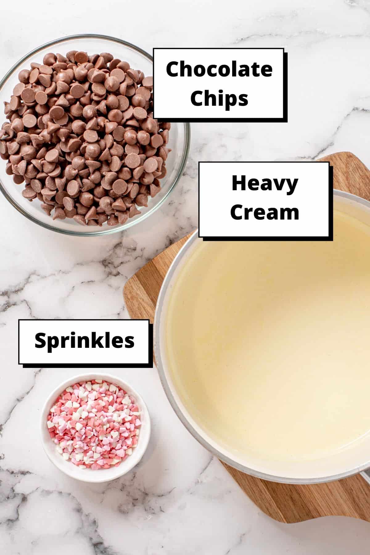 chocolate chips bowl, heart sprinkles bowl and heavy cream in a creamy saucepot