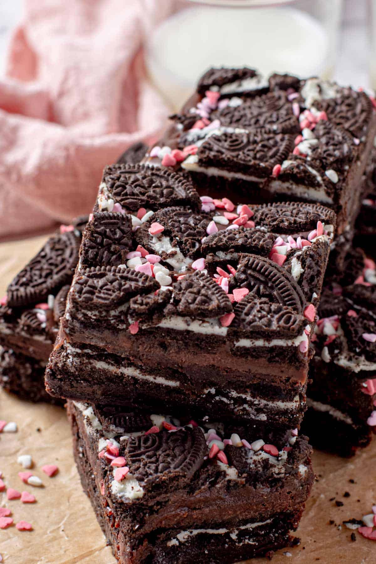 oreo brownie bars in two layers with heart sprinkles and chocolate ganache