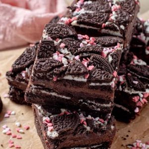 oreo brownie bars in two layers with heart sprinkles and chocolate ganache