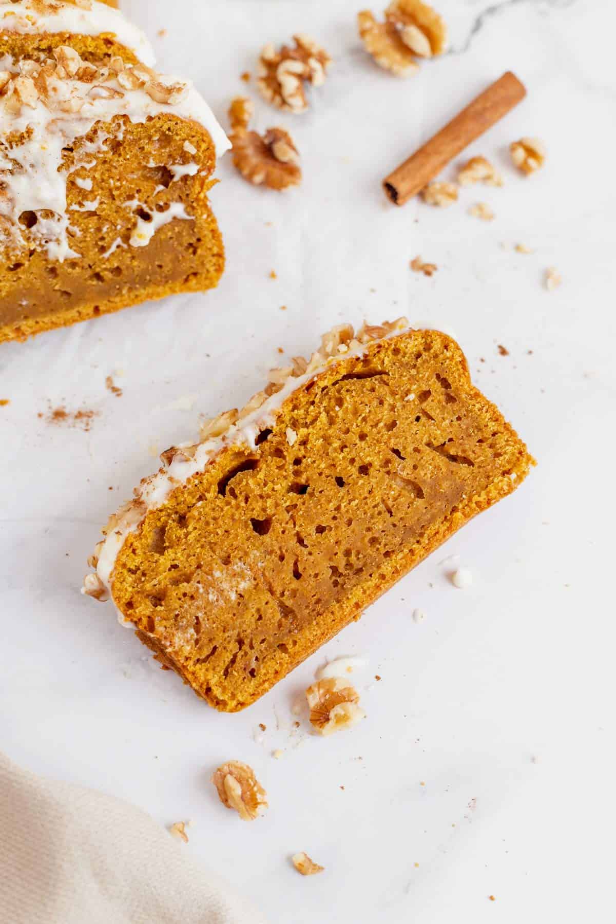 a slice of pumpkin bread with cream cheese frosting