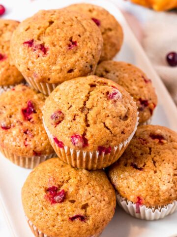a stack of Pumpkin Muffins With Cranberries