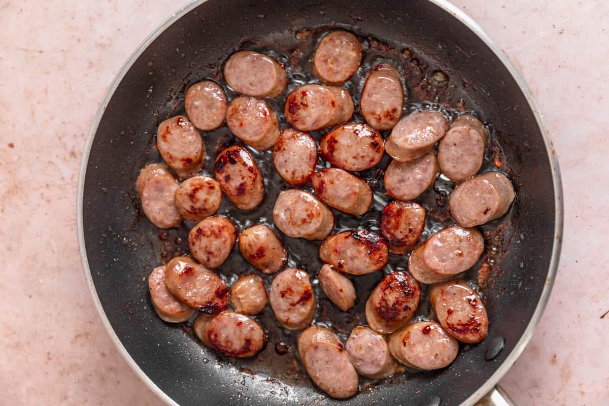 sliced sausage frying in the pan
