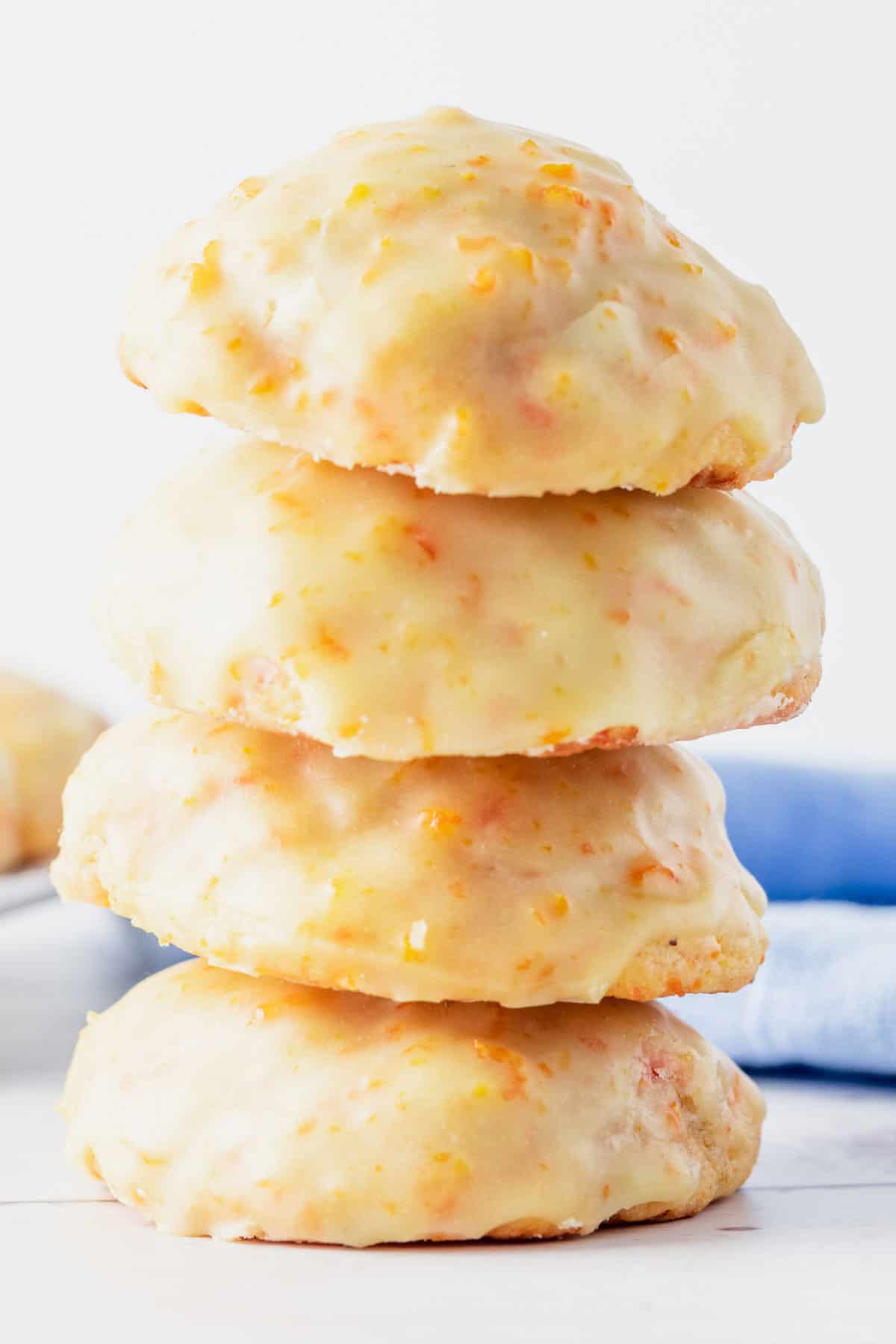 a stack of carrot cookies with orange icing