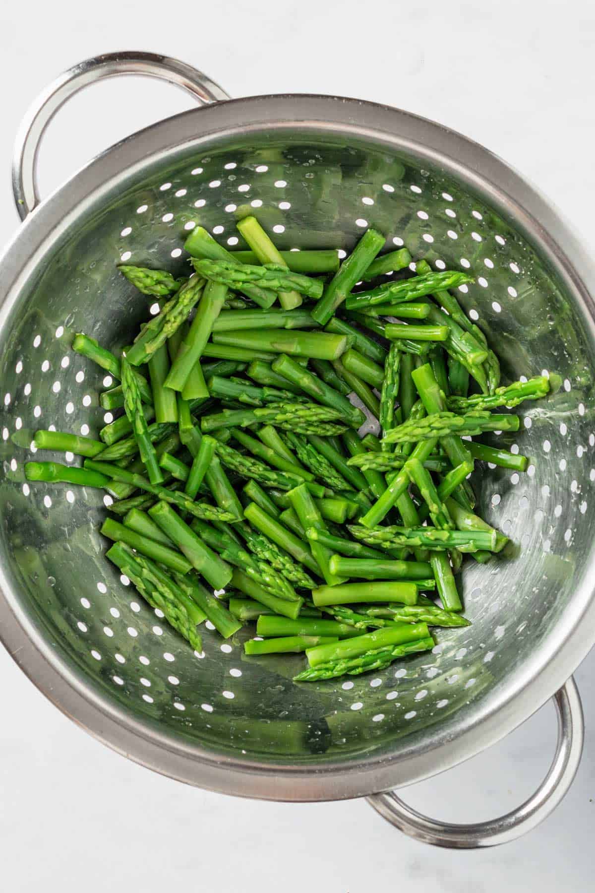 blanched asparagus in colander.