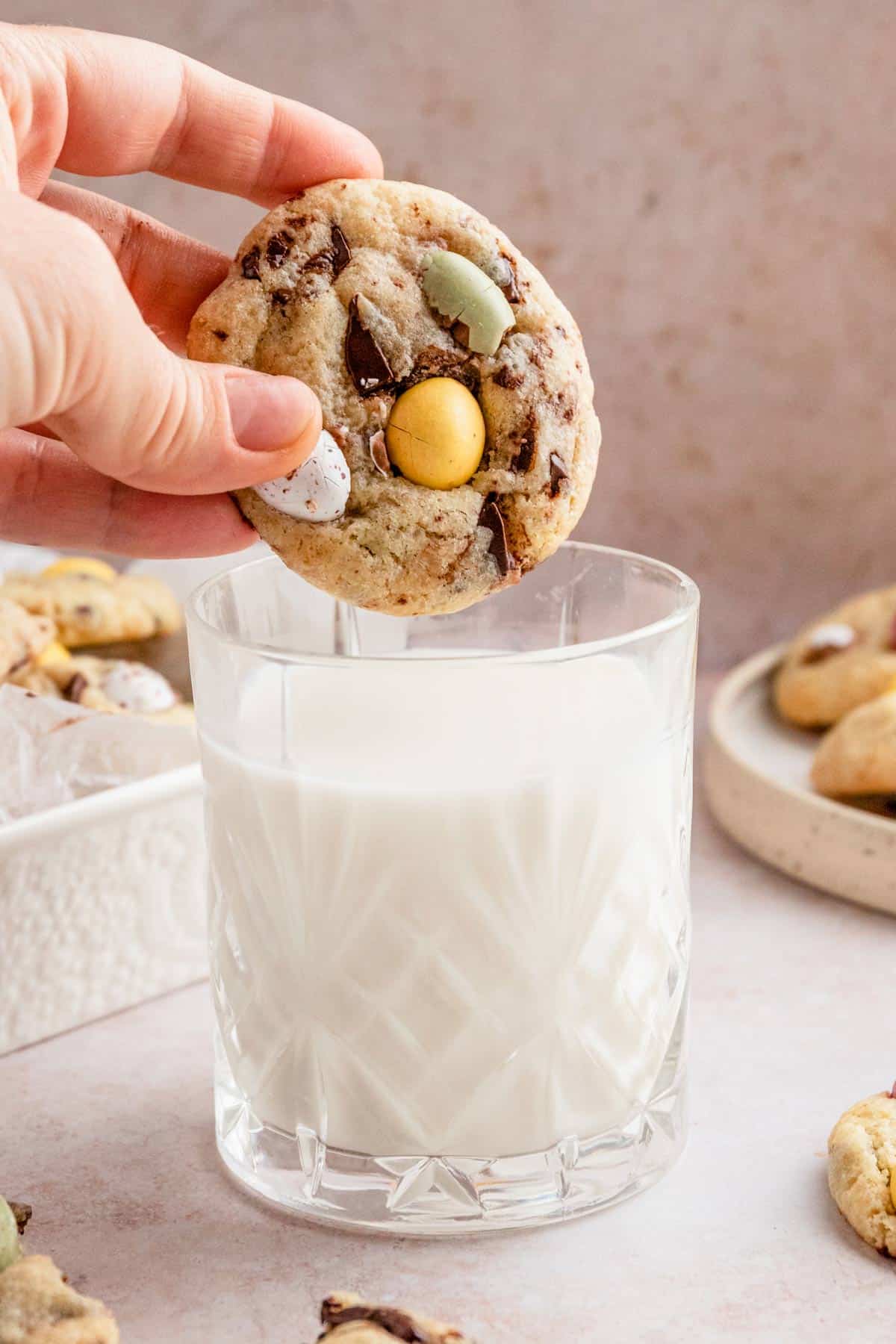 easter egg cookies dipped in a glass of milk