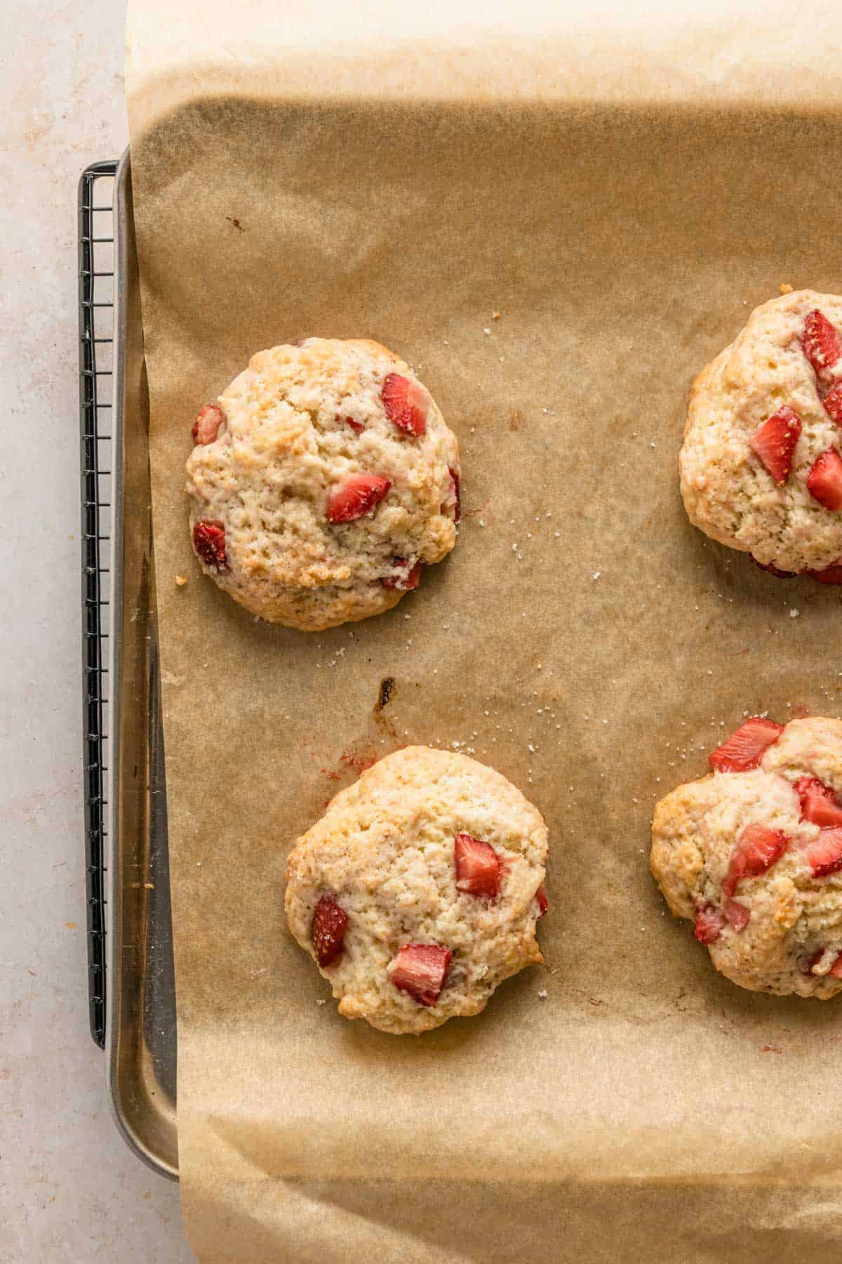 shortcake cookies with strawberries on baking sheet