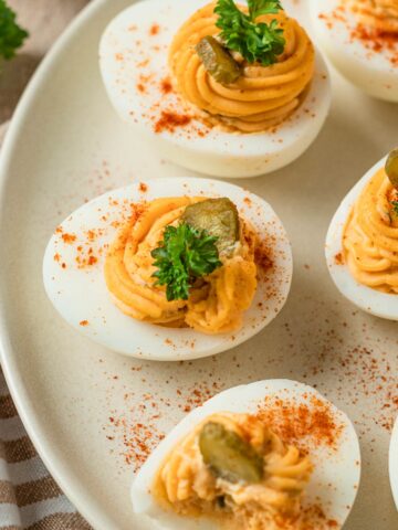 spicy deviled eggs with pickles hot sauce and paprika
