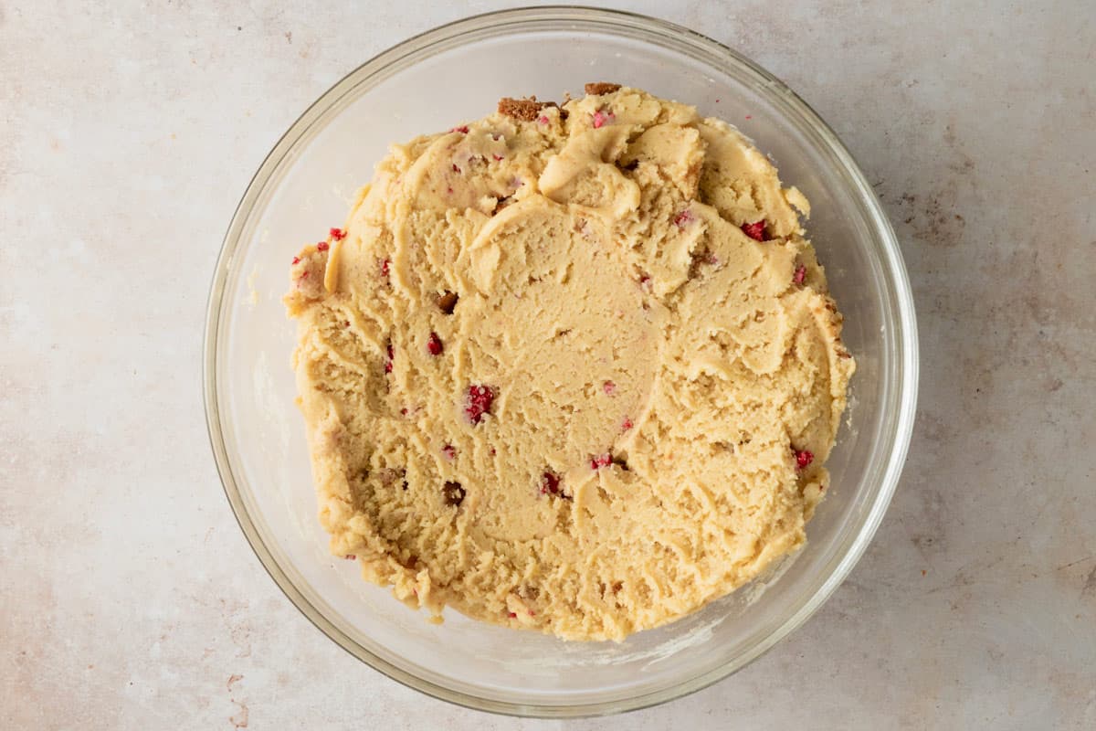 cream cheese and flour mixed with raspberries in a bowl