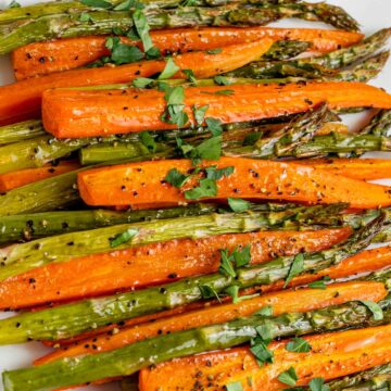 roasted carrots and asparagus in the oven on a serving platter with parsley