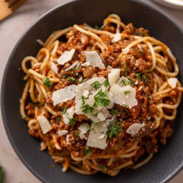 spaghetti served with bolognese sauce and parmesan