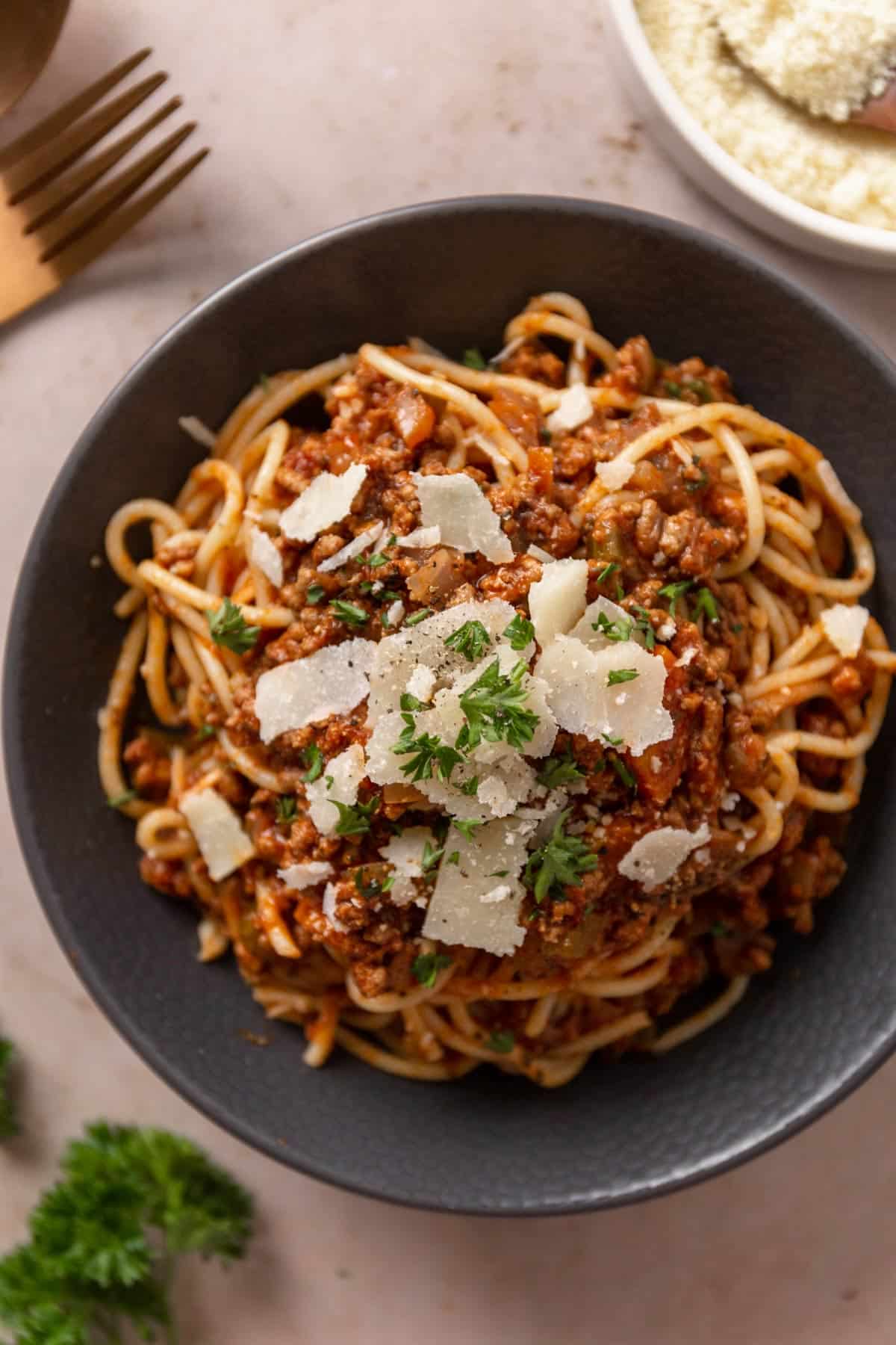 spaghetti served with bolognese sauce and parmesan