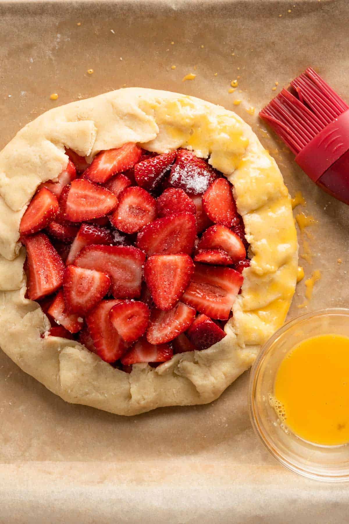 the edges of the strawberry galette brushed with egg wash