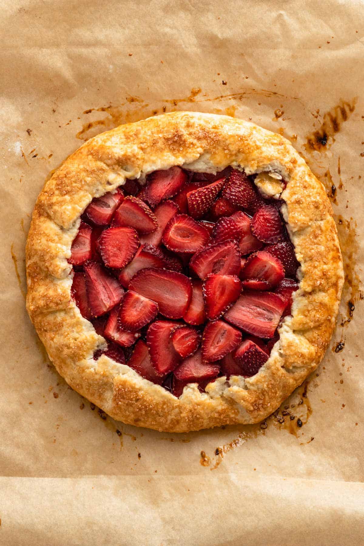 strawberry galette on parchment paper right after baking