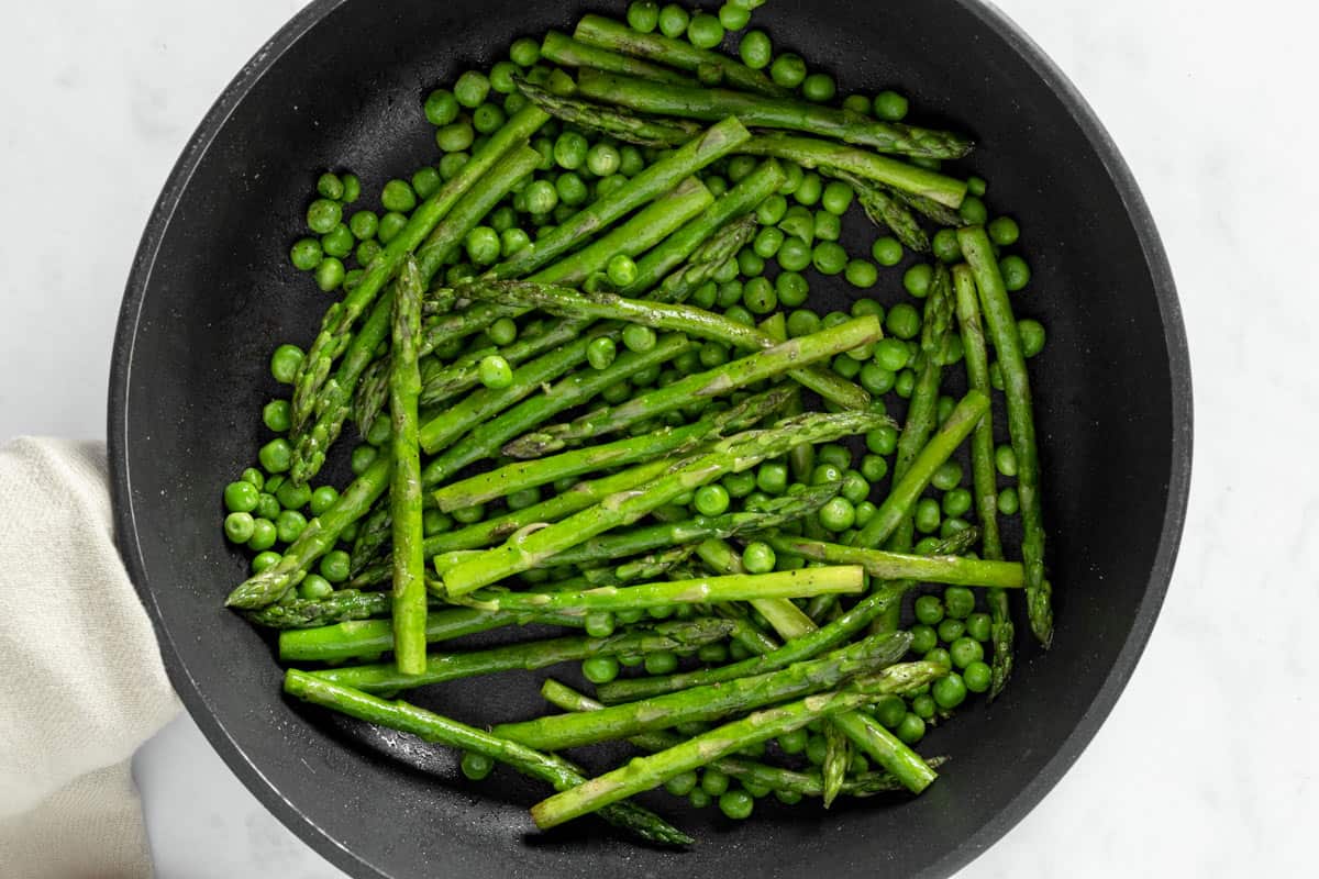 pan fried asparagus with peas in skillet