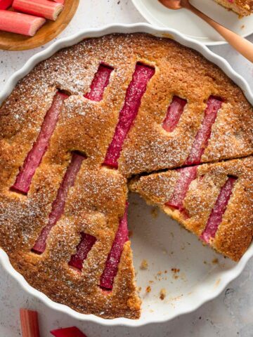 rhubarb pie with decorated rhubarb slices on top and powdered sugar