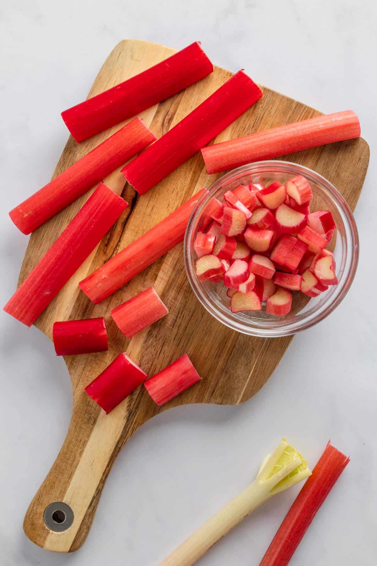 slices rhubarb on wooden cutting board