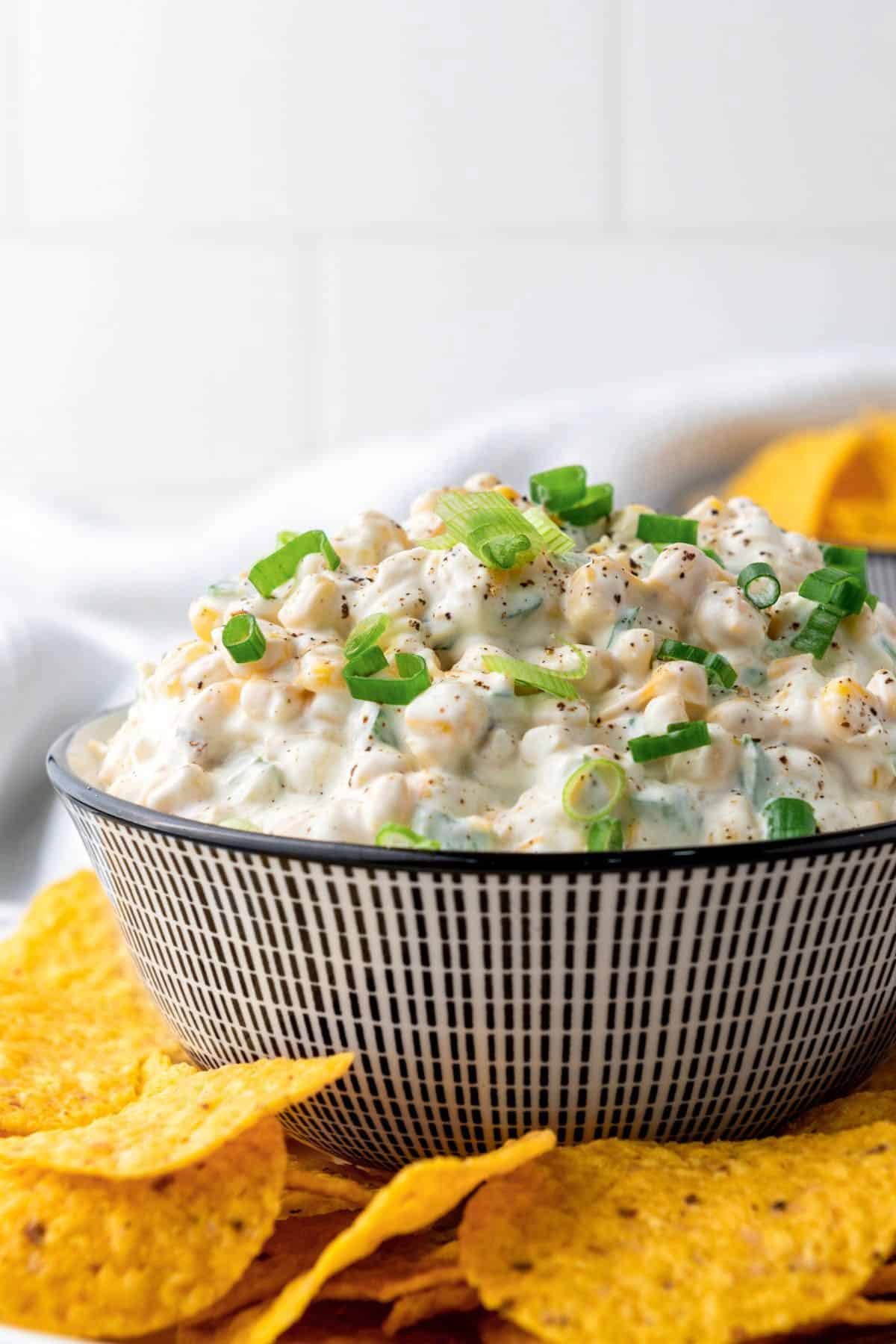 corn dip in a bowl and served with corn tortilla chips.