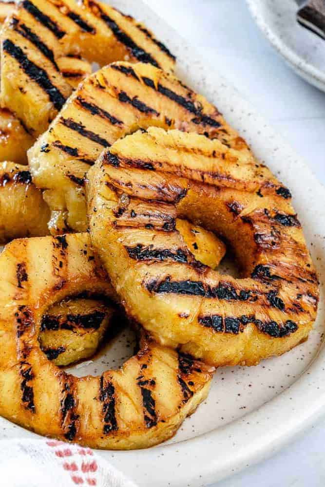 grilled charred pineapple slices on a plate.