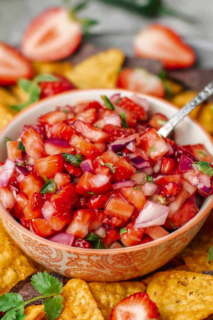 strawberry salsa in a colorful bowl served with tortilla chips.