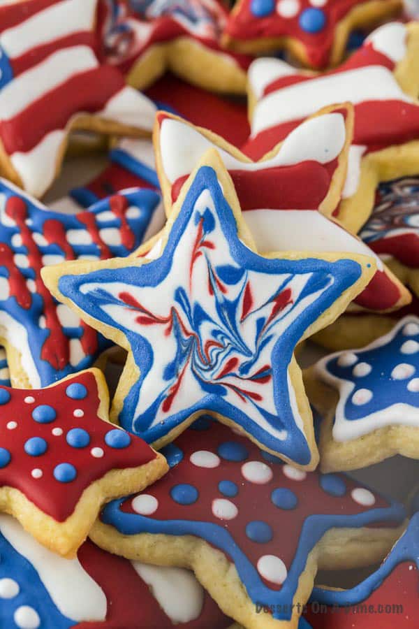 a stack of cut out fourth of july sugar cookies in different shapes.
