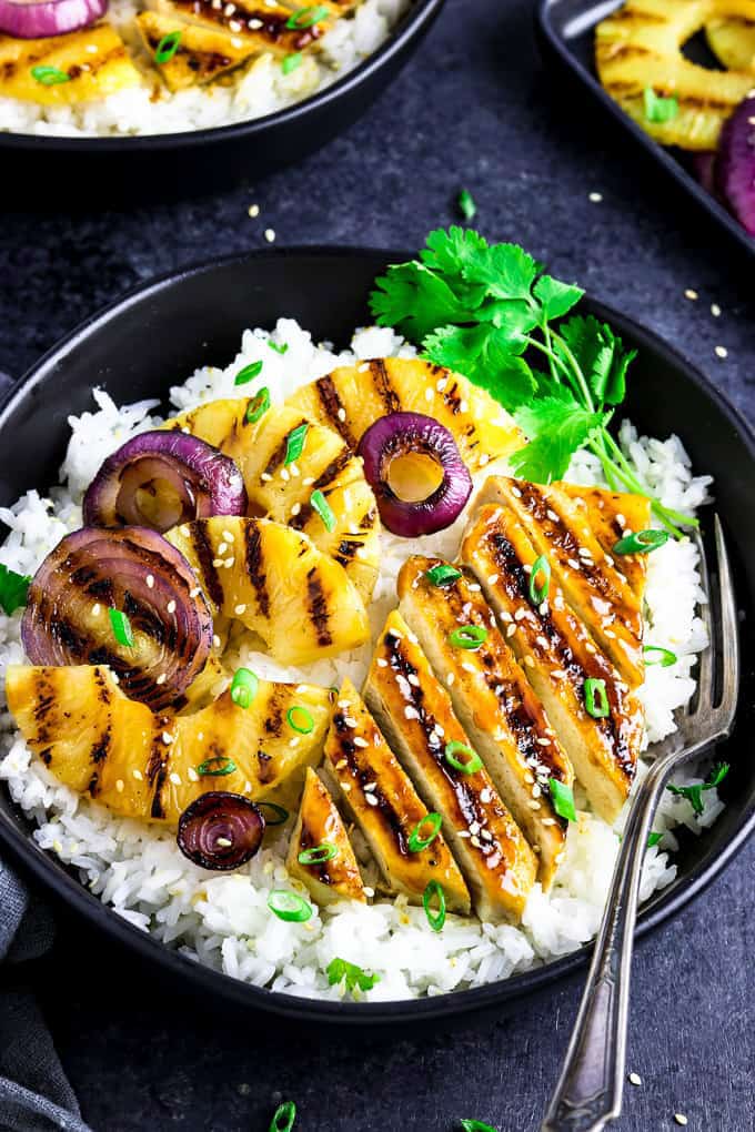 grilled pineapple slices and tofu served on a bed of rice.