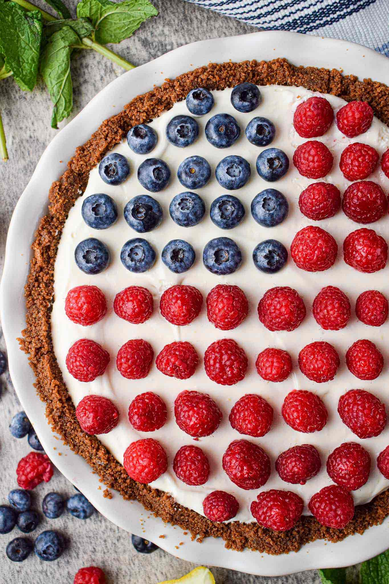 no bake pie with frosting and berries arranged on top resembling american flag.