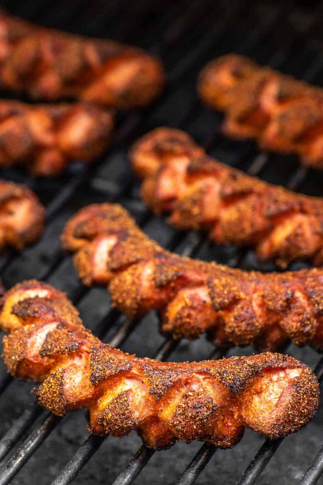 smoked hot dogs on a grill.