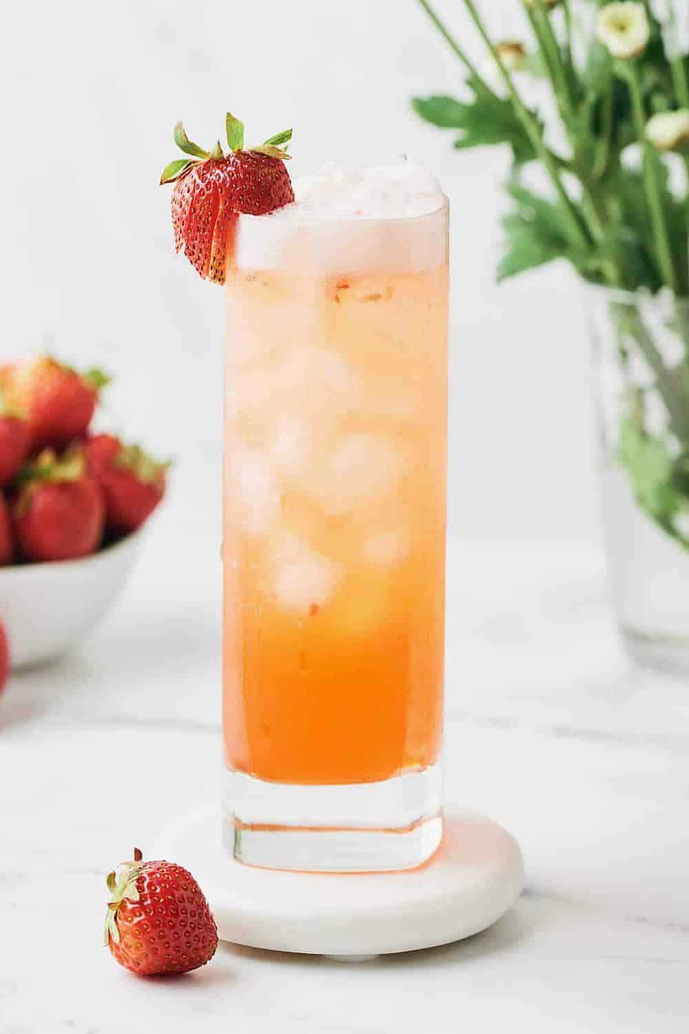 orange cocktail glass  decorated with strawberry.