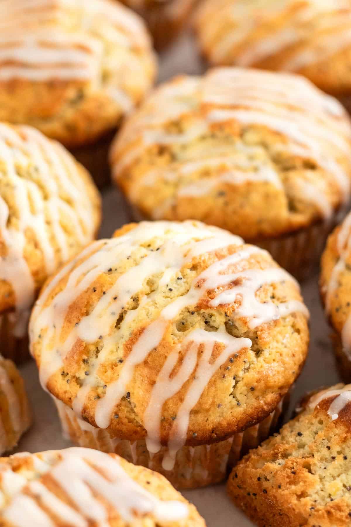a bunch of lemon poppy seed muffins with lemon sugar glaze.