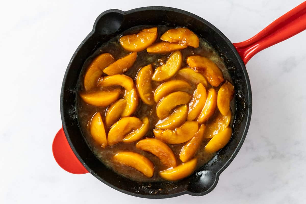 simmering peaches in skillet.
