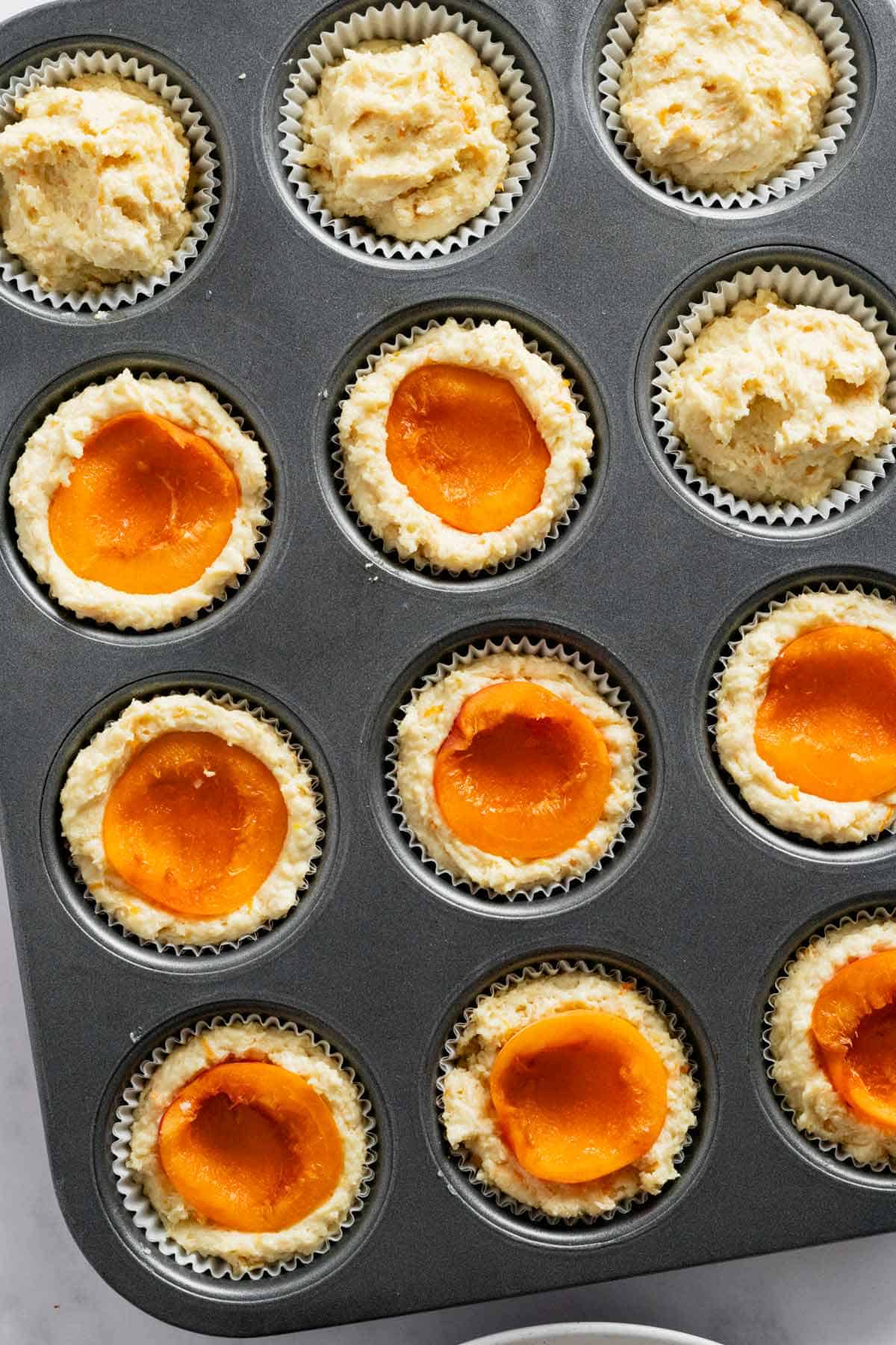apricot slices added on top of muffin batter.
