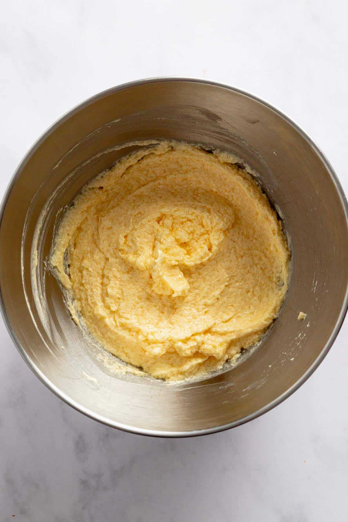 butter and sugar whisked in a bowl.