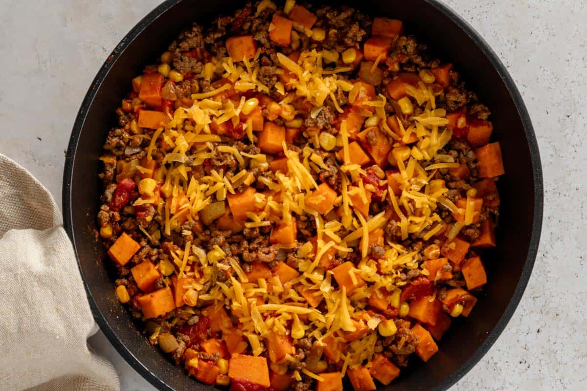 ground beef skillet topped with grated cheese.