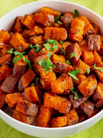 crispy roasted sweet potato cubes in a bowl.