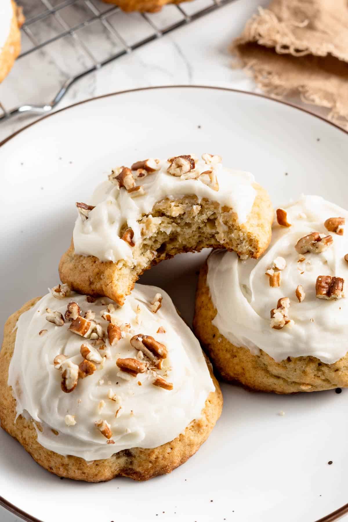banana cookies with frosting and pecans.