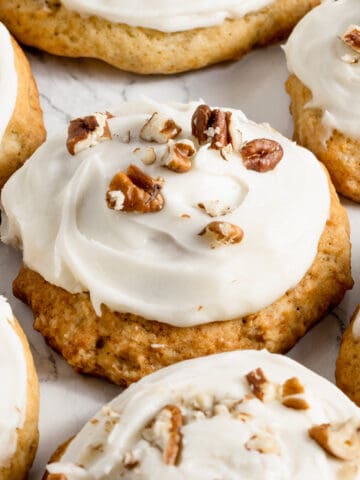 banana cookies with frosting and pecans.