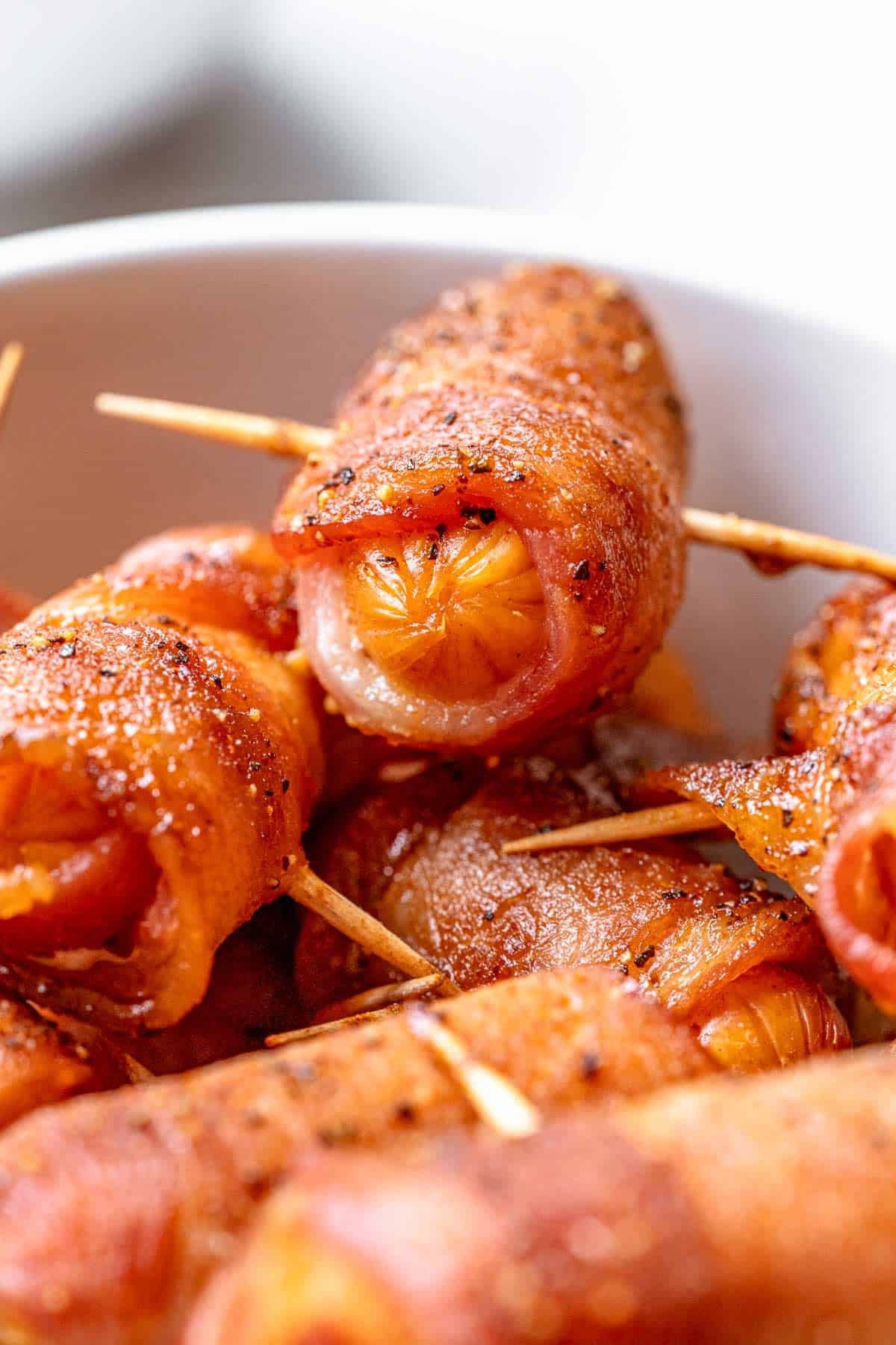 a bowl of ready to serve bacon wrapped smokies.