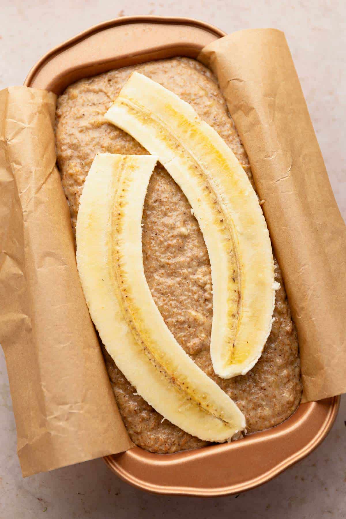 2 slices of banana on top of banana bread batter.