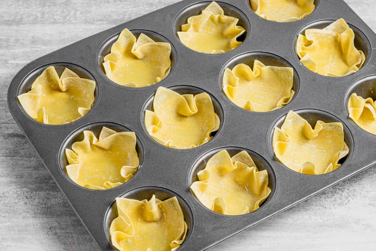 wonton wrappers in muffin tins.