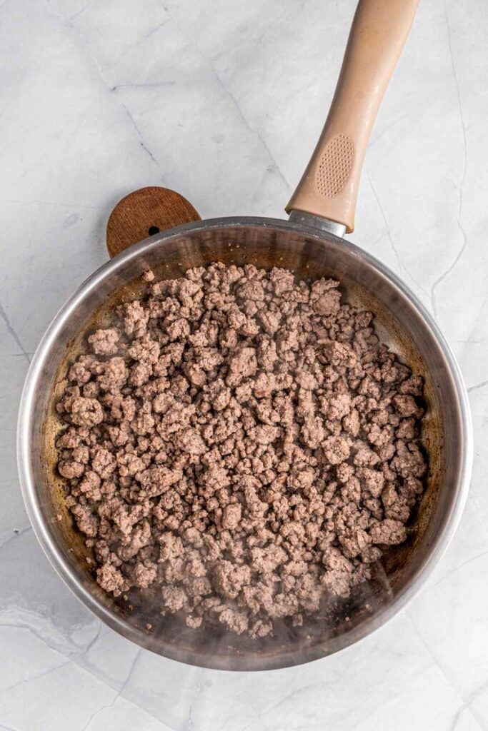 ground beef cooking in skillet.