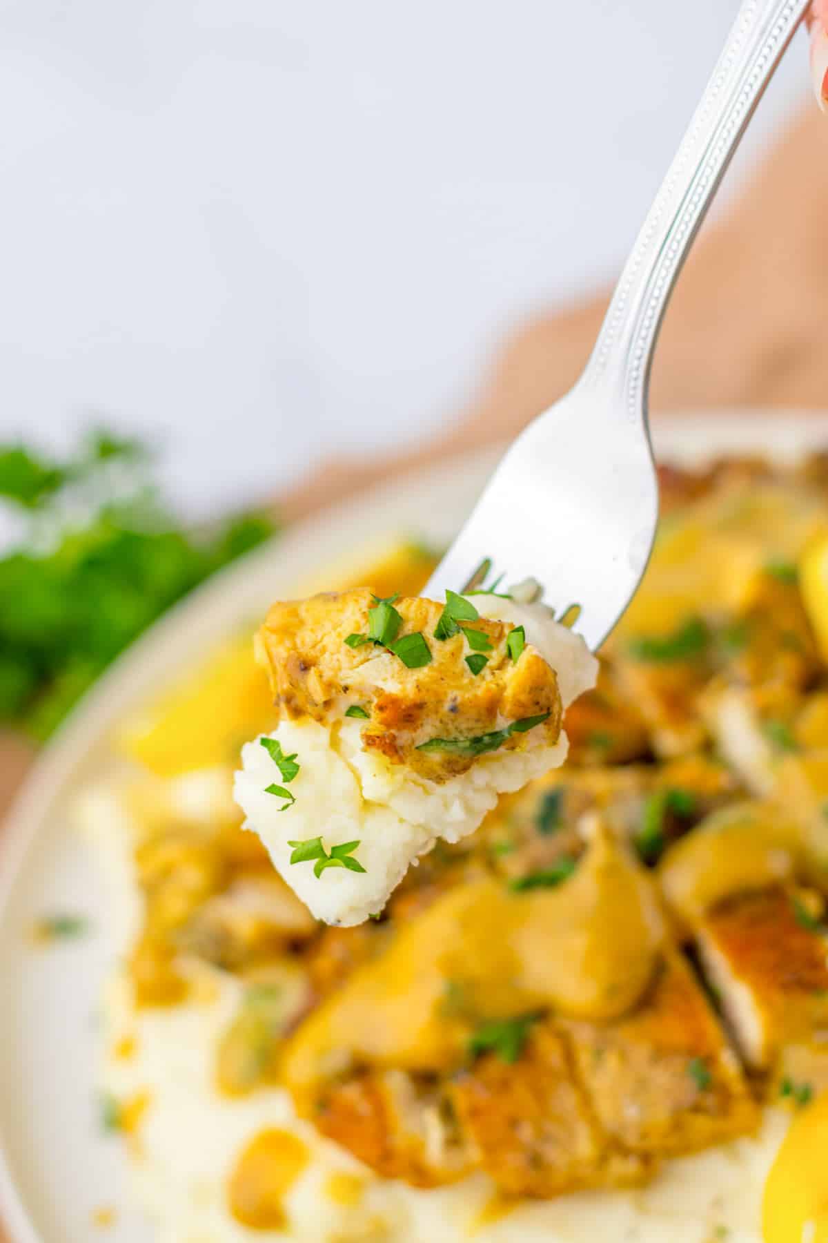 lemon butter chicken breasts with mashed potatoes.