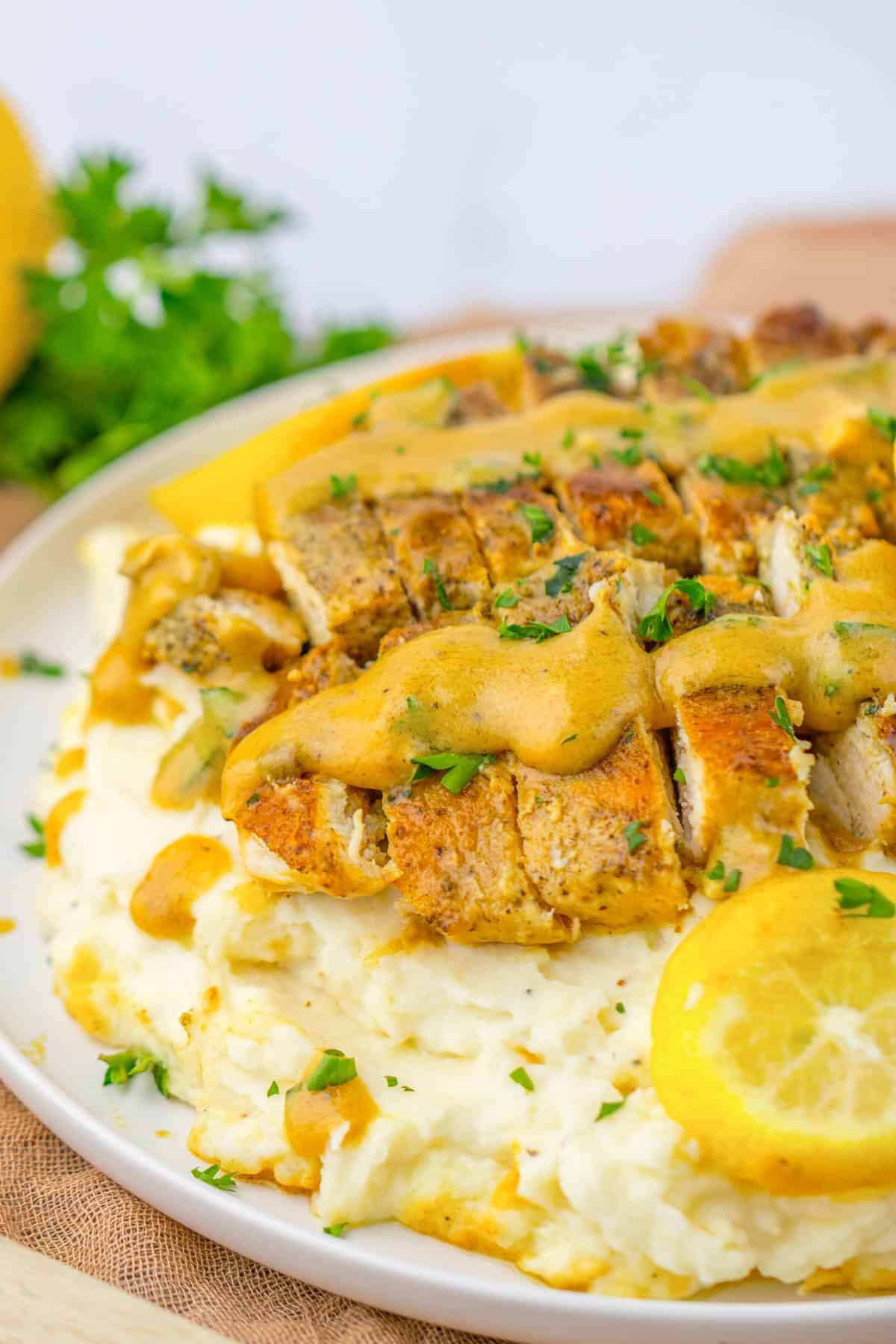 lemon butter chicken breasts with mashed potatoes.
