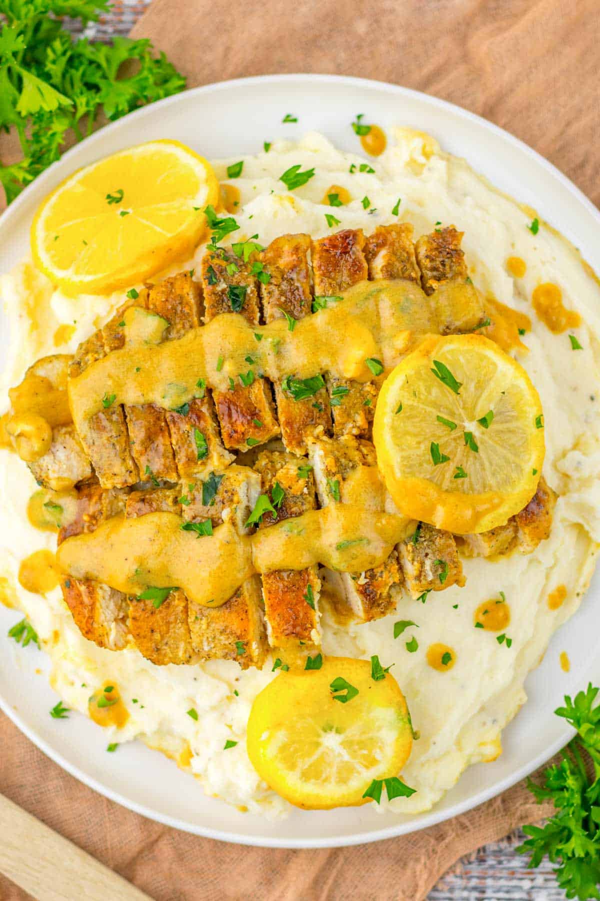 lemon butter chicken breasts with mashed potatoes.