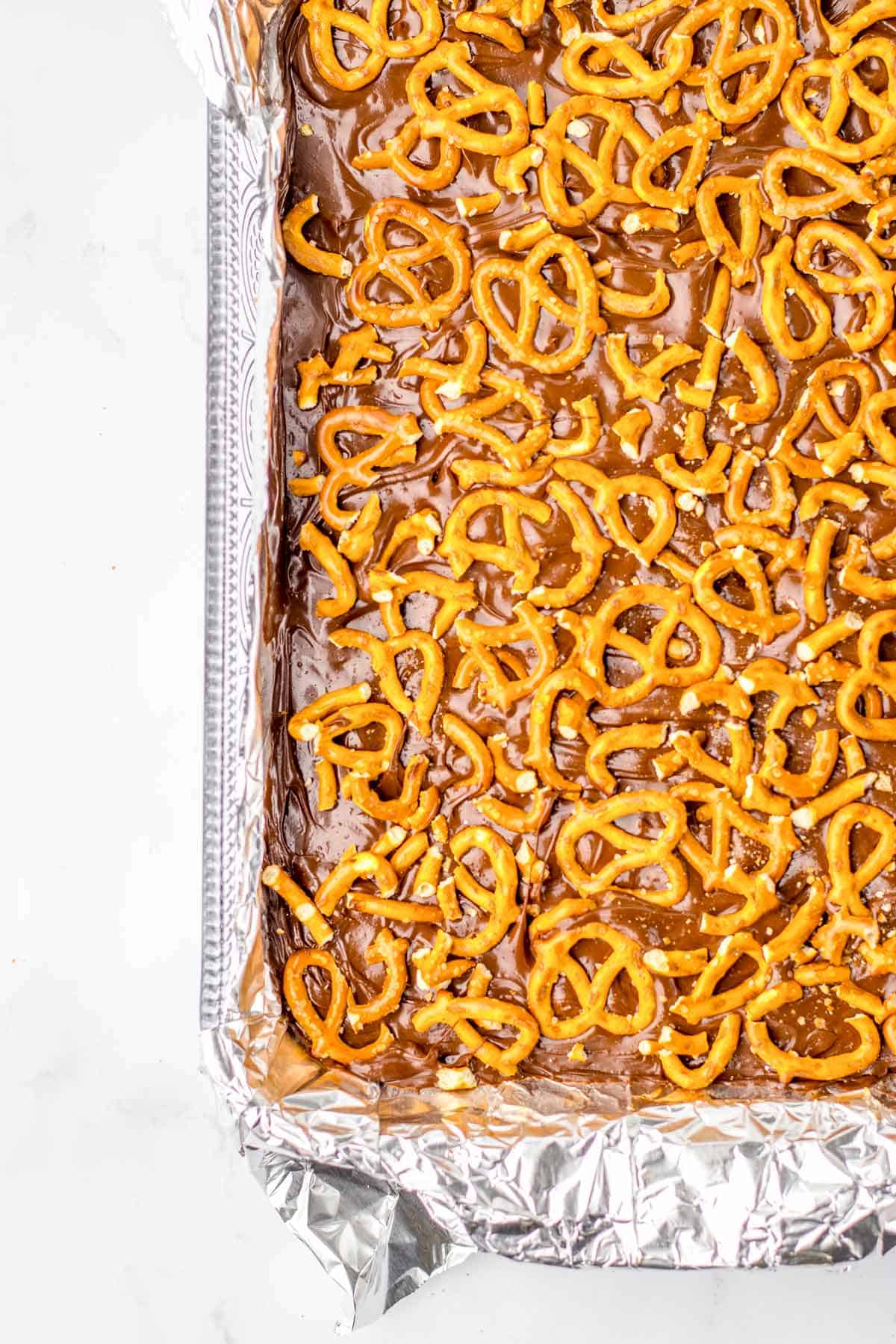 chilled no bake peanut butter bars batter with pretzels.