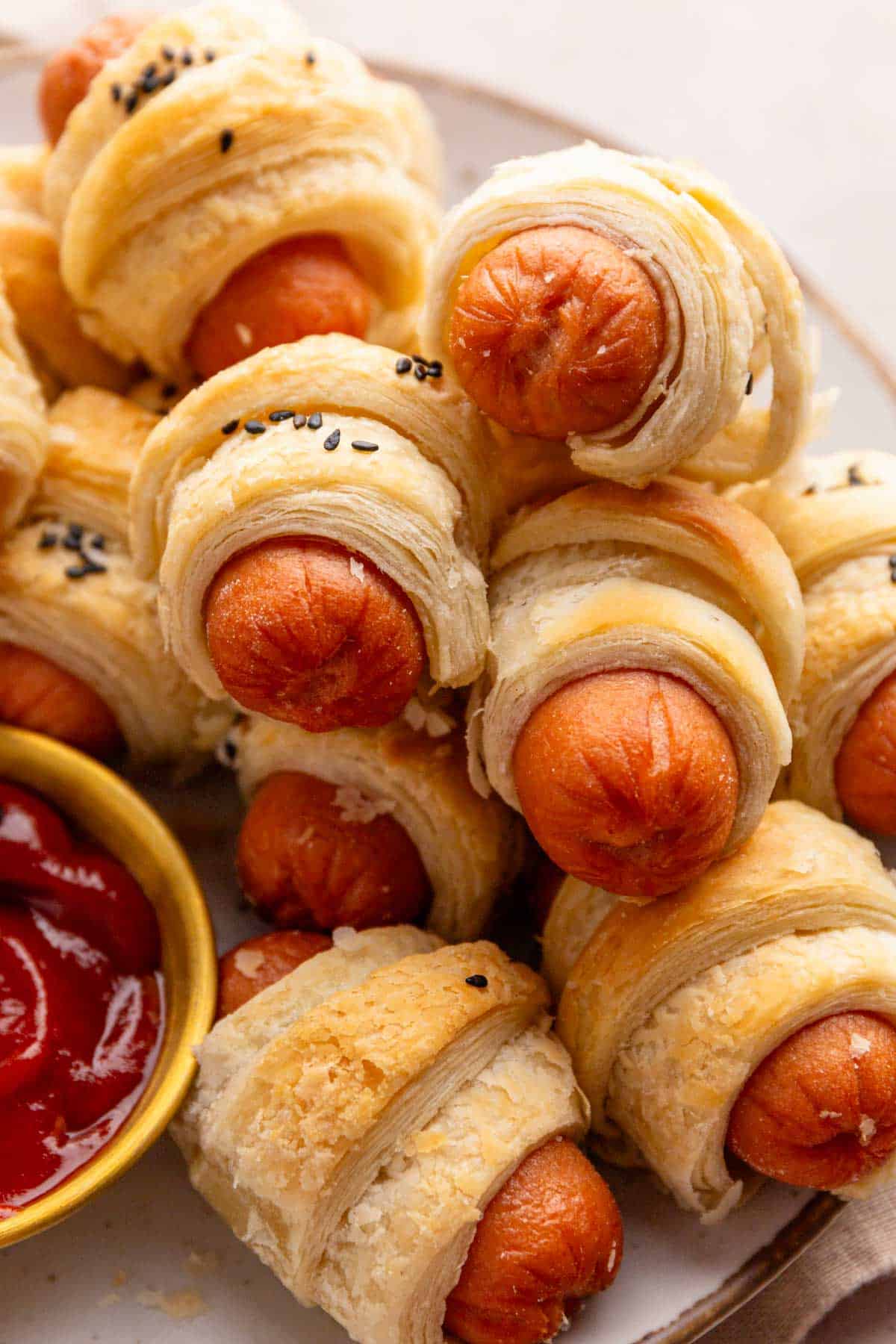a stack of puff pastry pigs in blanket.