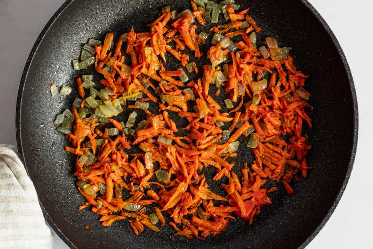 carrots and onions in skillet.