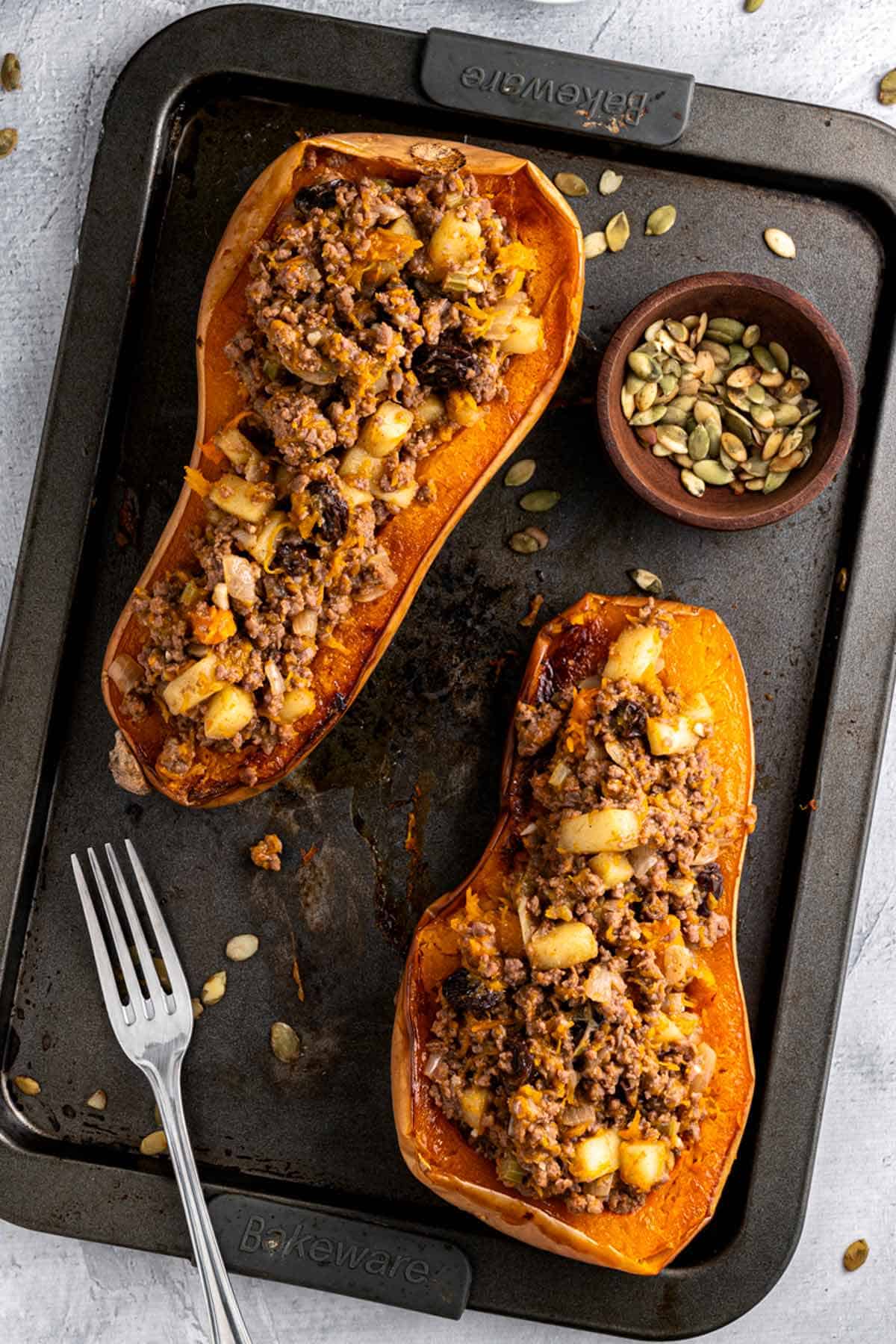 beef stuffed butternut squash on baking sheet.