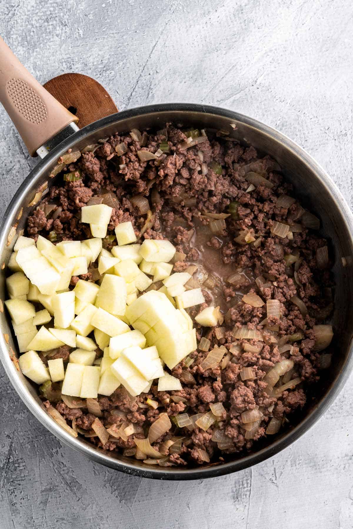 adding onion to sauteed sausage.